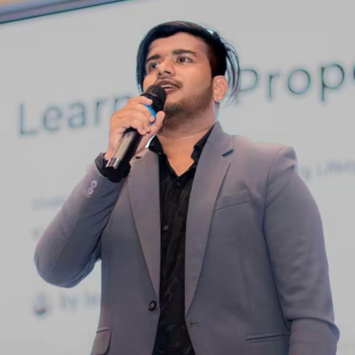 Isuru speaking at an event